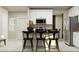 Modern kitchen featuring white cabinets, stainless steel appliances, and a breakfast bar with seating at 2879 Transformation Way, Clermont, FL 34714