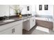 Bright bathroom featuring a large mirror, double vanity, and a soaking tub at 3008 Protagonist St, Kissimmee, FL 34746