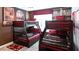 Themed ' bedroom with two sets of bunk beds and a rich maroon color scheme at 3008 Protagonist St, Kissimmee, FL 34746