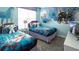 Themed ' bedroom with two beds, light blue walls, and Frozen cartoon decor for a whimsical touch at 3008 Protagonist St, Kissimmee, FL 34746
