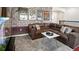 Spacious bonus room featuring unique brick wallpaper and a comfortable leather couch at 3008 Protagonist St, Kissimmee, FL 34746