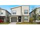 Modern two-story home with neutral siding, a one-car garage, and a well-manicured front yard at 3008 Protagonist St, Kissimmee, FL 34746