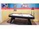Air hockey table in the brightly painted game room with colorful walls and playful decor at 3008 Protagonist St, Kissimmee, FL 34746