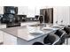 Modern kitchen featuring sleek countertops, stainless steel appliances, and a breakfast bar with seating at 3008 Protagonist St, Kissimmee, FL 34746