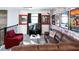 Relax in this cozy themed living room featuring movie decor and a comfortable leather sectional sofa at 3008 Protagonist St, Kissimmee, FL 34746