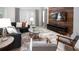 Cozy living area with comfortable seating, a decorative rug, and a wood accent wall with a mounted TV at 3008 Protagonist St, Kissimmee, FL 34746