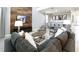 Spacious living room featuring a large sectional sofa, wood accent wall, and an adjacent dining area at 3008 Protagonist St, Kissimmee, FL 34746
