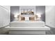 Bright, minimalist main bedroom with a platform bed, soft colors, and stylish decor at 3008 Protagonist St, Kissimmee, FL 34746