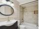 Bathroom showcasing elegant fixtures, vanity, and a tiled shower-tub combination, providing a spa-like experience at 520 Hamlet Dr, Port Orange, FL 32127