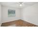 Bright bedroom with hardwood floors and a window with blinds, offering a serene and comfortable space at 520 Hamlet Dr, Port Orange, FL 32127
