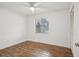 Bright bedroom with hardwood floors, ceiling fan, and closet, offering a serene and comfortable space at 520 Hamlet Dr, Port Orange, FL 32127