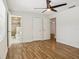Inviting bedroom featuring hardwood floors and an open doorway to a bathroom, providing a seamless and functional layout at 520 Hamlet Dr, Port Orange, FL 32127