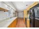 Open kitchen with a view into an adjacent room, stainless steel appliances, and tiled floor at 520 Hamlet Dr, Port Orange, FL 32127