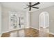 Bright room with french doors and tile floor. Large ceiling fan and neutral walls at 520 Hamlet Dr, Port Orange, FL 32127
