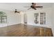 Spacious room with wood-look tile floors, white textured walls, and french doors to the backyard at 520 Hamlet Dr, Port Orange, FL 32127