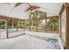 Enclosed sunroom with a view of the swimming pool, offering a serene space for relaxation and entertainment at 520 Hamlet Dr, Port Orange, FL 32127
