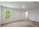 Bright empty bedroom with carpet flooring and a large window at 572 Bay Leaf Dr, Poinciana, FL 34759