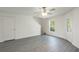 Bright room featuring wood-look flooring, a ceiling fan, and a glass door for natural light at 572 Bay Leaf Dr, Poinciana, FL 34759