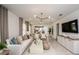 Bright and open living room featuring modern decor, neutral tones, and seamless flow to the dining area at 6780 Sw 90Th Loop, Ocala, FL 34476