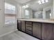 Bright bathroom featuring a double sink vanity, modern fixtures, and natural light at 1101 Pavia Dr, Apopka, FL 32703