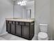 Bright bathroom with double sink vanity, neutral countertops and stylish tile flooring at 1101 Pavia Dr, Apopka, FL 32703
