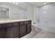 Bright bathroom with double sink vanity, neutral countertops and tub shower at 1101 Pavia Dr, Apopka, FL 32703