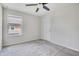 Bright bedroom featuring a ceiling fan and window, with plush carpeting at 1101 Pavia Dr, Apopka, FL 32703