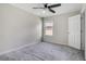 Neutral bedroom featuring a ceiling fan and window, with plush carpeting at 1101 Pavia Dr, Apopka, FL 32703