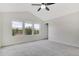 Light-filled bedroom with vaulted ceiling, large windows, and plush carpeting at 1101 Pavia Dr, Apopka, FL 32703