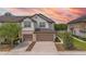 Townhome exterior showcases two-car garage, charming curb appeal, and well-maintained surroundings at 1101 Pavia Dr, Apopka, FL 32703