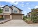 Inviting townhome with a well-maintained lawn, concrete driveway, and two-car garage at 1101 Pavia Dr, Apopka, FL 32703