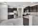 Modern kitchen with stainless steel appliances, dark cabinetry, and granite countertops at 1101 Pavia Dr, Apopka, FL 32703