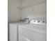 Functional laundry area with white appliances and wire shelving at 1101 Pavia Dr, Apopka, FL 32703