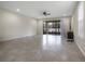 Spacious living room with tile flooring, neutral walls, and sliding door access to lanai at 1101 Pavia Dr, Apopka, FL 32703