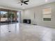 Spacious living room with tile flooring, a ceiling fan, and sliding glass doors to the patio at 1101 Pavia Dr, Apopka, FL 32703