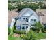 Beautiful aerial view of a two-story white home with lush landscaping and a gray roof at 14563 Bahama Swallow Blvd, Winter Garden, FL 34787