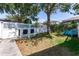 Fenced backyard features lawn, trees, and Adirondack chairs at 14563 Bahama Swallow Blvd, Winter Garden, FL 34787