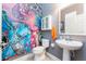 Fun powder room featuring a colorful mural, pedestal sink, and white fixtures at 14563 Bahama Swallow Blvd, Winter Garden, FL 34787