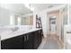 Bright bathroom with double vanity, dark cabinets, and walk-in shower at 14563 Bahama Swallow Blvd, Winter Garden, FL 34787