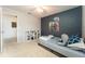 Well-lit bedroom featuring toys, a colorful accent wall, and an adjacent doorway at 14563 Bahama Swallow Blvd, Winter Garden, FL 34787