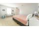 Bright bedroom featuring a gray upholstered bed frame, nightstand, and natural light from a window at 14563 Bahama Swallow Blvd, Winter Garden, FL 34787