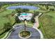 Aerial view of a community pool and clubhouse with a serene lake as the backdrop at 14563 Bahama Swallow Blvd, Winter Garden, FL 34787