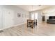 Dining area features a wooden table with seating for four, light gray walls, and door to outside area at 14563 Bahama Swallow Blvd, Winter Garden, FL 34787