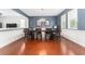 Elegant dining room with hardwood floors, wainscoting, and stylish lighting, perfect for gatherings at 14563 Bahama Swallow Blvd, Winter Garden, FL 34787
