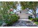 Rear view of home showcasing a two-car garage and screened-in patio at 14563 Bahama Swallow Blvd, Winter Garden, FL 34787