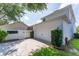 Exterior of home with a two-car garage, white fence, and landscaping at 14563 Bahama Swallow Blvd, Winter Garden, FL 34787