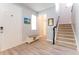 Inviting foyer with light wood flooring, staircase, entry bench, and stylish décor, creating a warm welcome at 14563 Bahama Swallow Blvd, Winter Garden, FL 34787