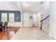 Open-concept foyer with light wood flooring, staircase, entry bench, and stylish décor, blending functionality and aesthetics at 14563 Bahama Swallow Blvd, Winter Garden, FL 34787