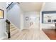 Bright foyer featuring light wood floors, a staircase with dark wood trim, and an open layout at 14563 Bahama Swallow Blvd, Winter Garden, FL 34787