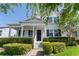 Charming two-story home with a welcoming front porch and lush landscaping, complete with a neatly manicured lawn at 14563 Bahama Swallow Blvd, Winter Garden, FL 34787